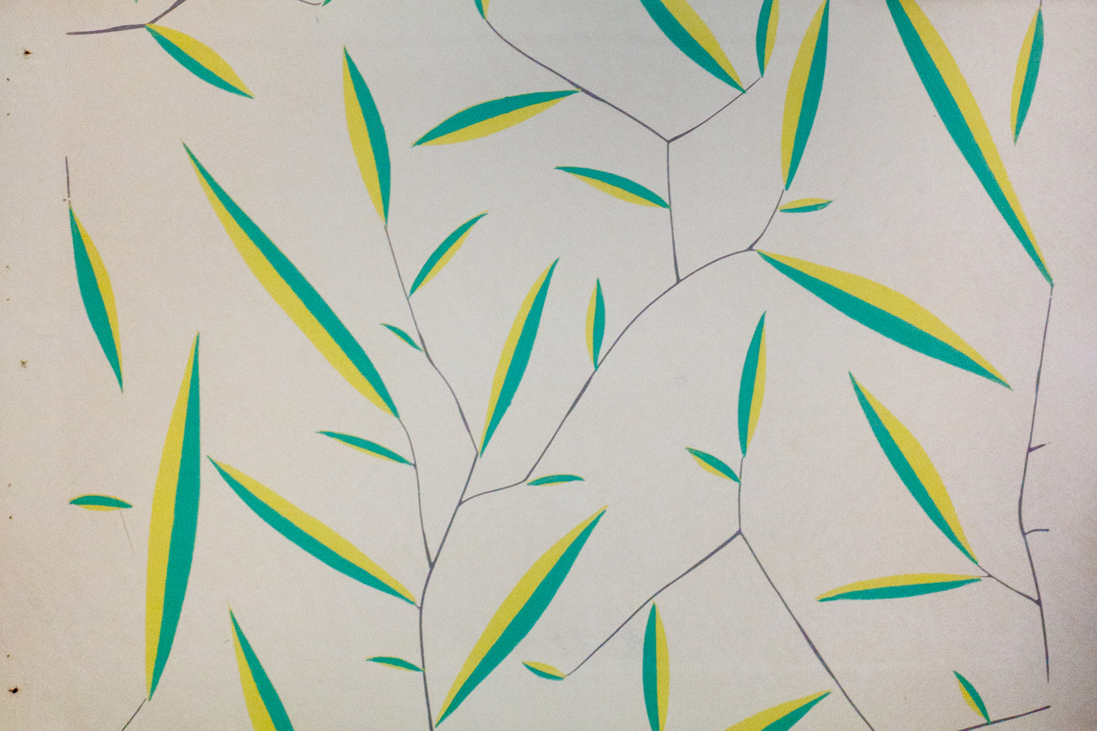 Thin green and yellow leaves are connected with thin black lines to create a wallpaper design.